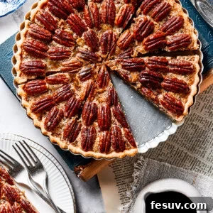 Decadent Pecan Pie Perfection 6 A slice of pie on a small serving dish, next to the larger pie.
