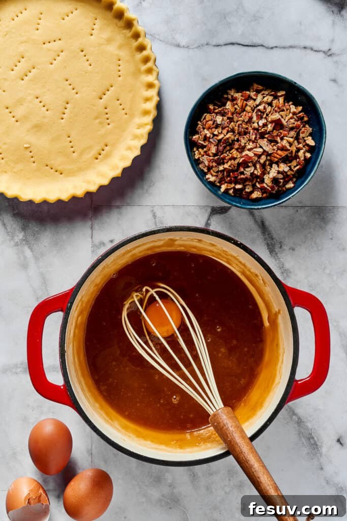 Decadent Pecan Pie Perfection 4 Beating eggs into cooled maple syrup mixture.