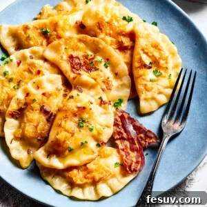 Handcrafted Pierogi Delights 12 Homemade potato-filled dumplings on a blue plate with a fork.