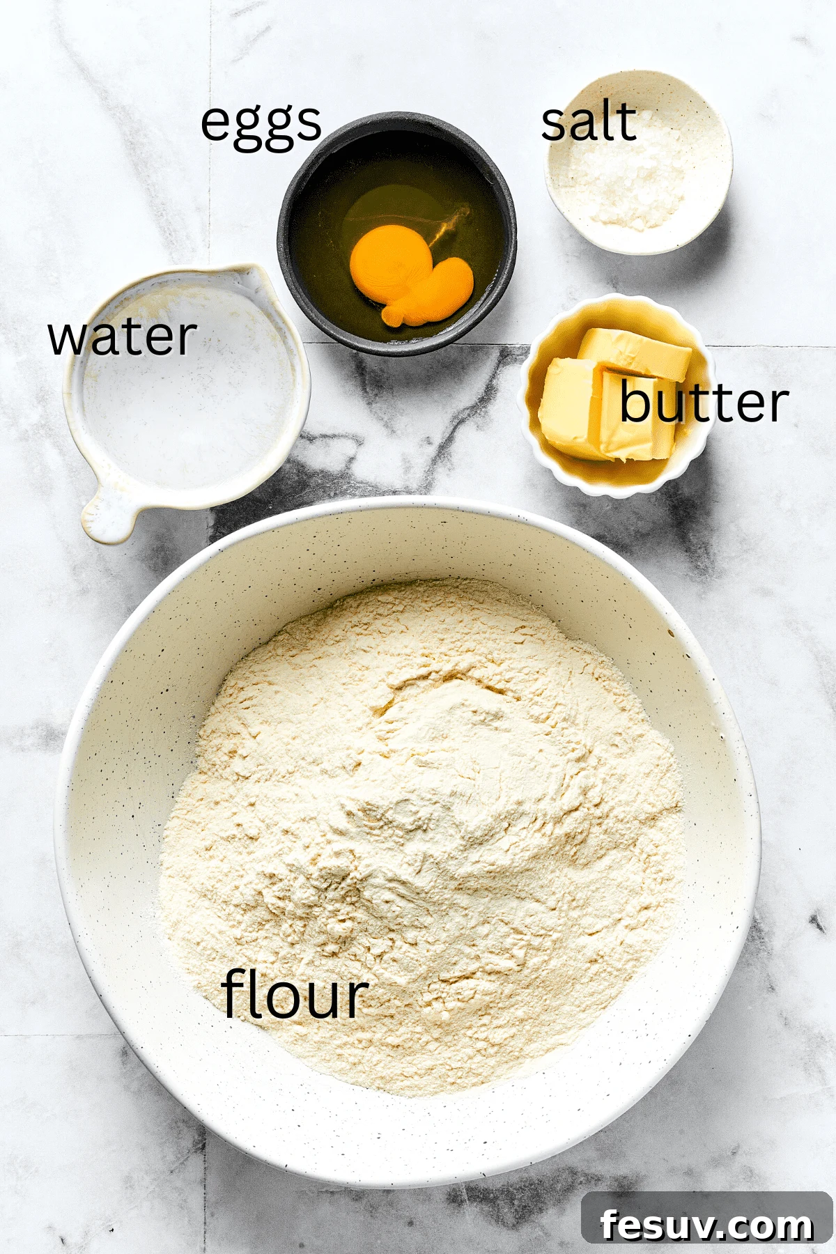 Topped with caramelized onion and crispy bacon, this easy Homemade Pierogi Recipe features a traditional cheese and potato filling. Yum! Ingredients for pierogi dough: water, eggs, salt, butter, and all-purpose flour.