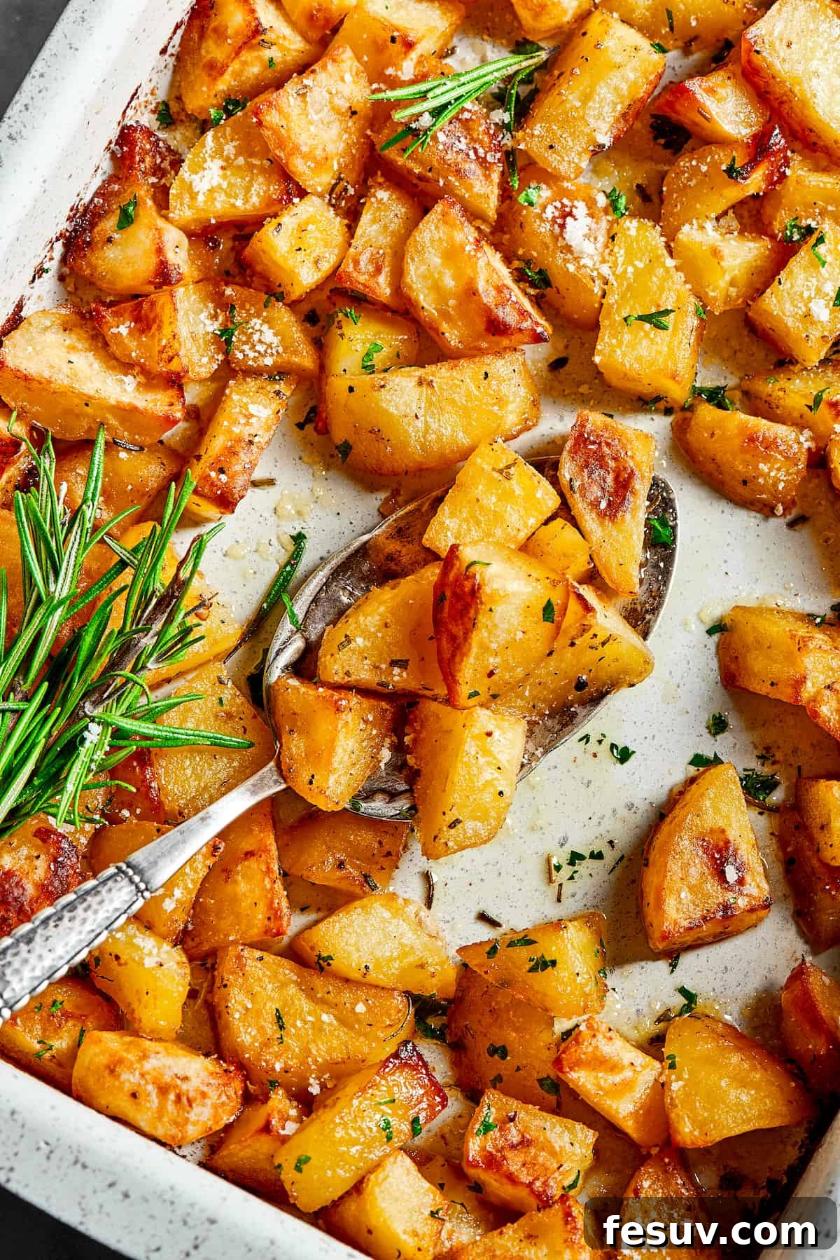 ed Potatoes are crisp, buttery, and easy to make. With a simple seasoning of salt, pepper, and rosemary, they're irresistible! A baking dish with seasoned potatoes inside.