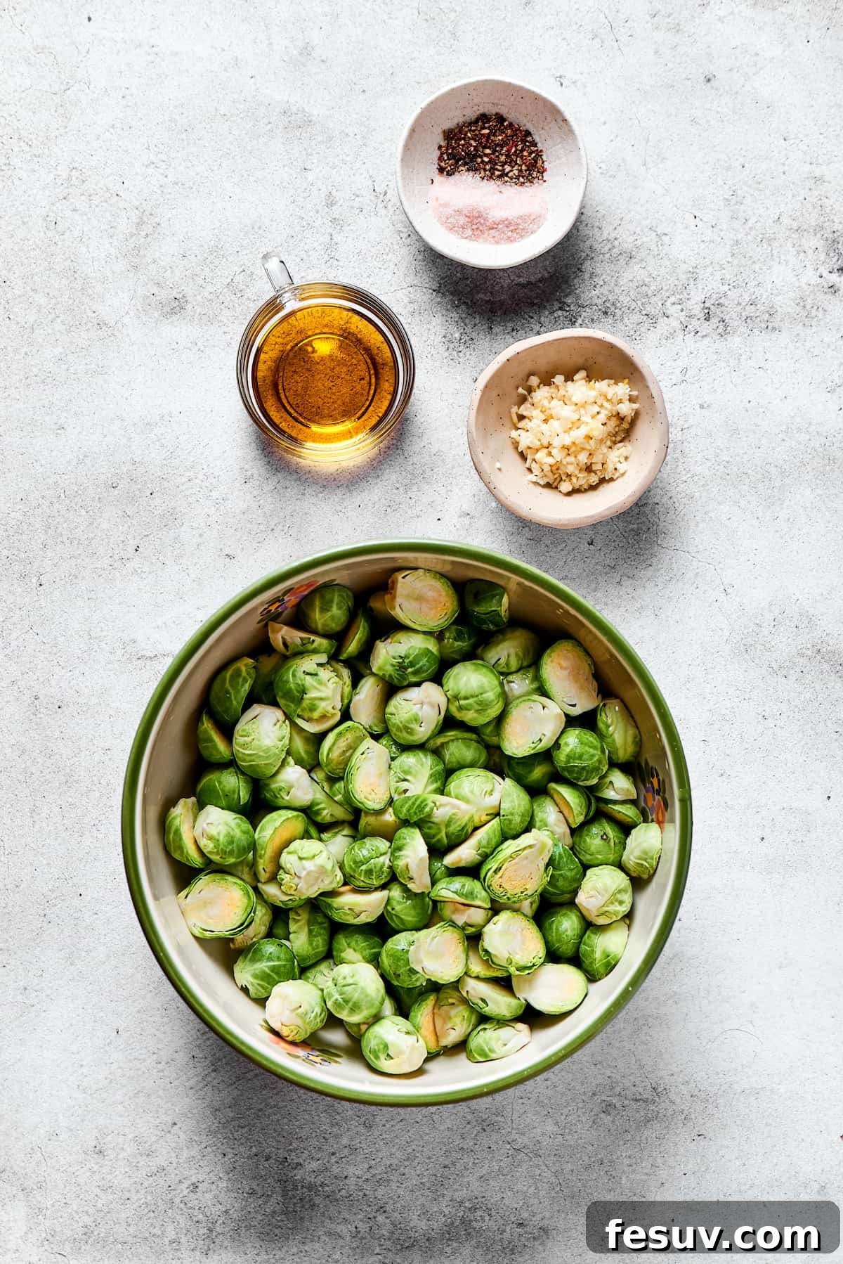 Crispy Brussels Perfection 2 From top: Himalayan salt and pepper, olive oil, fresh garlic cloves, and fresh brussels sprouts.