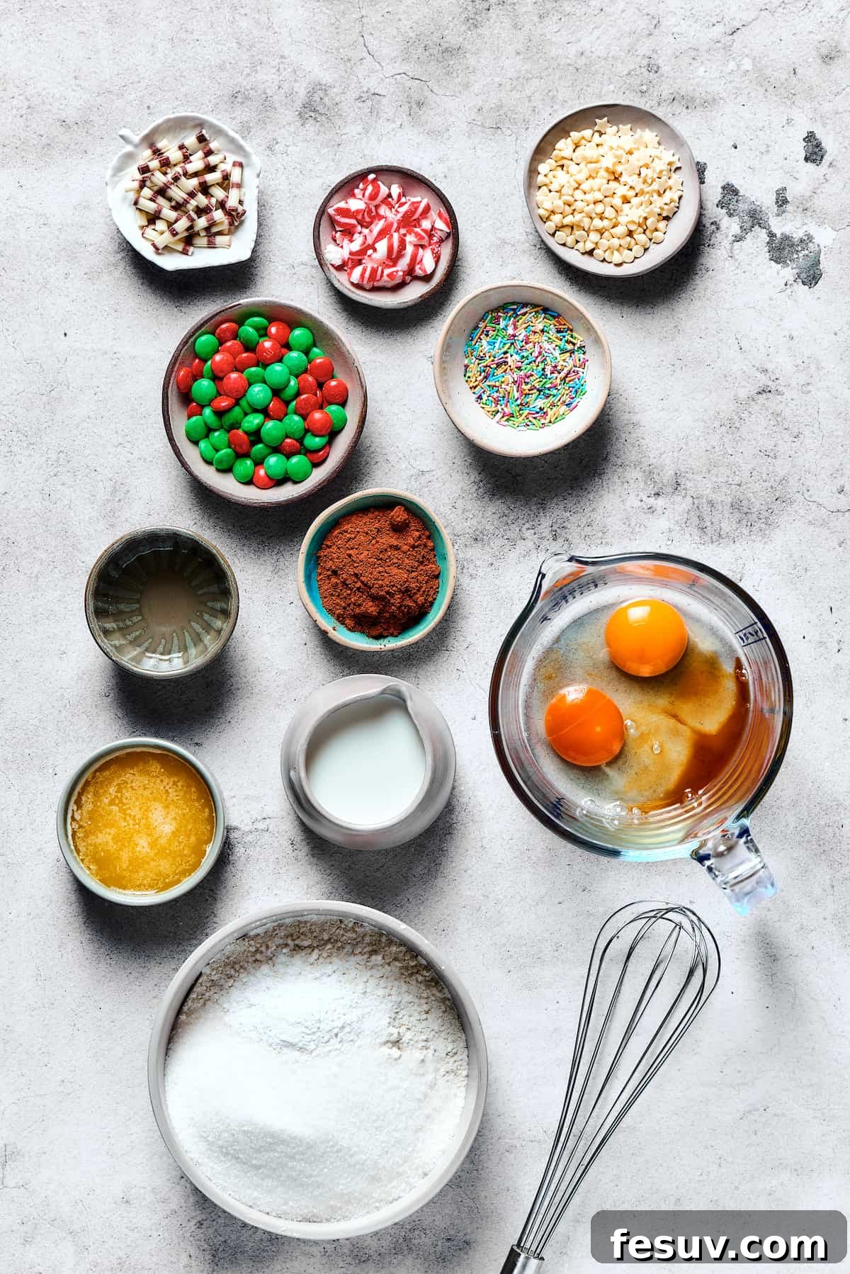 An overhead shot showcasing all the essential ingredients for making delightful cake mix cookies, neatly arranged on a rustic wooden table.