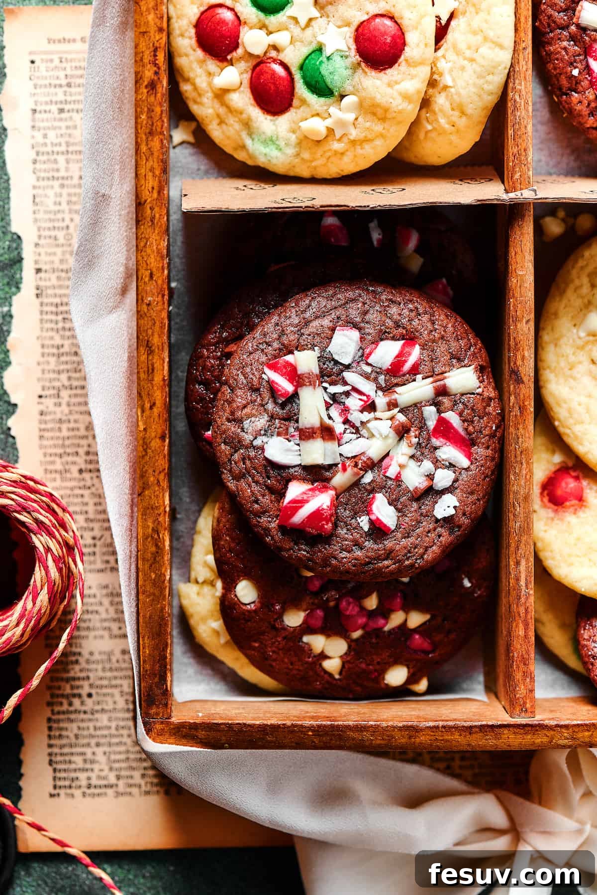 A close-up shot of a richly chocolate Christmas cake mix cookie, beautifully decorated with a generous sprinkle of crushed peppermint pieces.