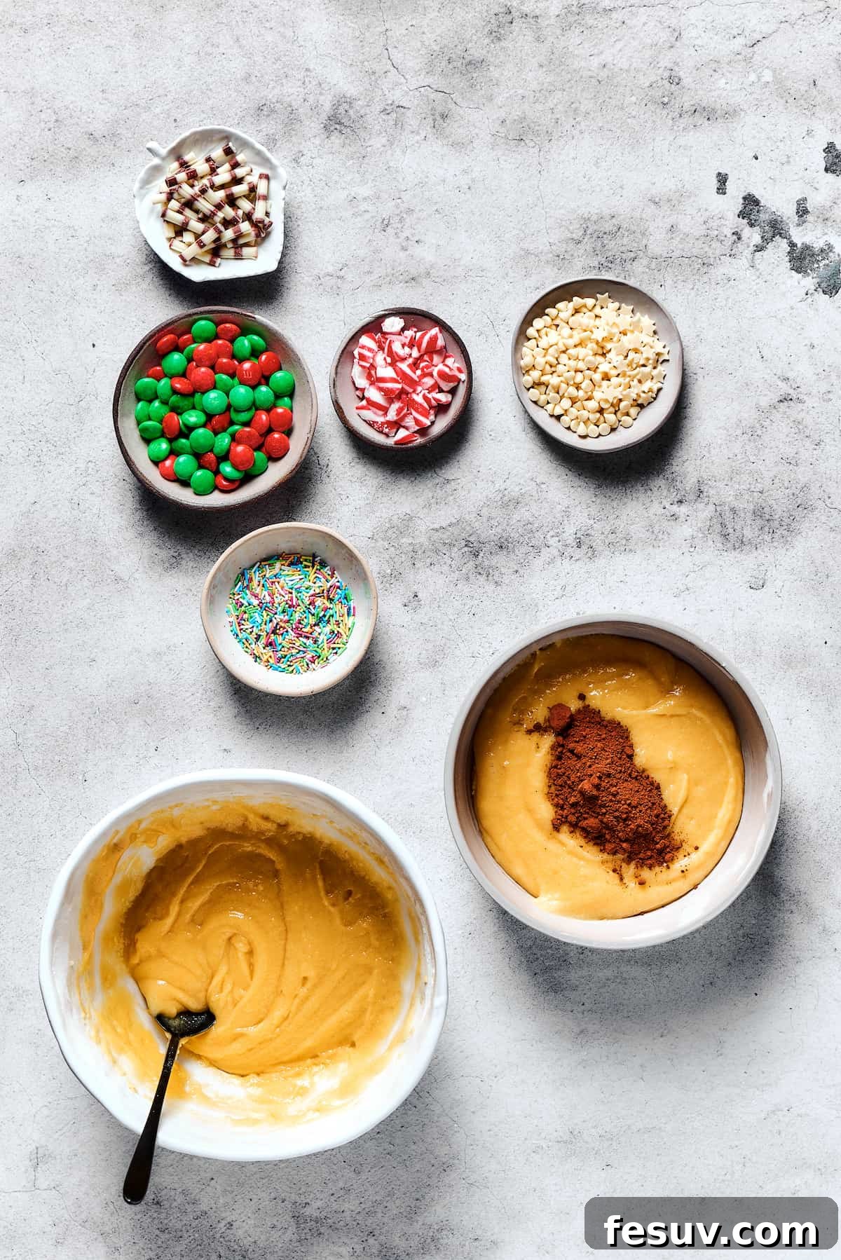 Cocoa powder is carefully being incorporated into one half of the cookie dough, transforming it into a rich chocolate mixture.