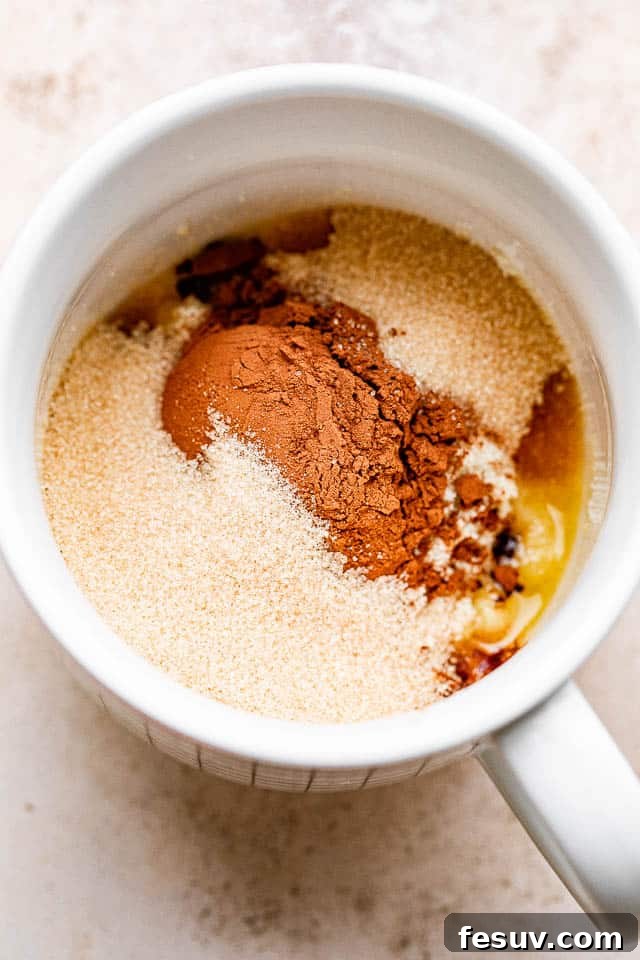 This moist and indulgent Chocolate Mug Cake cooks in one minute inside the microwave. It is the most perfect, individual-sized dessert! Cocoa powder, flour, sugar, and melted butter combined in a mug, forming the base of the chocolate mug cake batter.