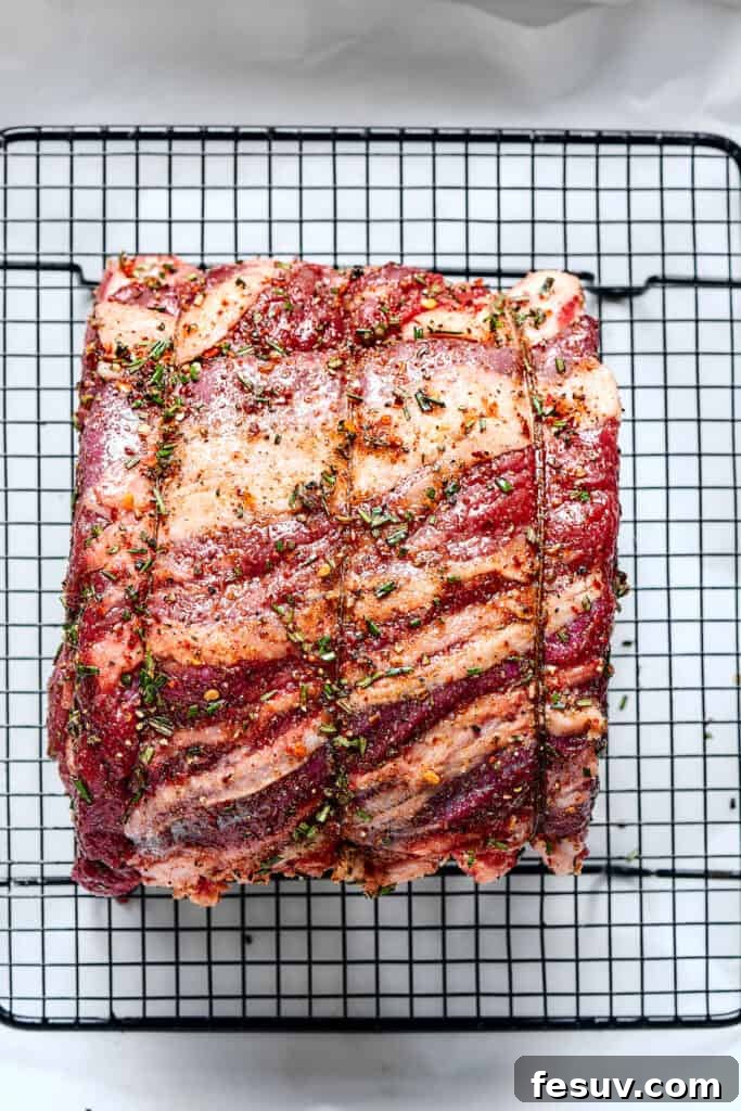 Regal Rib Roast 4 Setting a tied rib roast on a roasting rack.