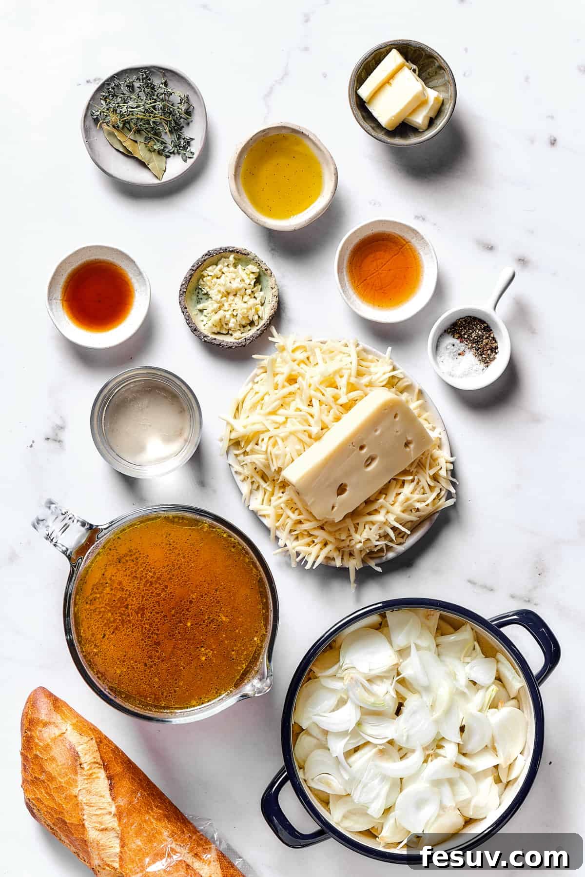 Caramelized Onion Elixir 2 All ingredients for French onion soup, including thinly sliced onions, fresh herbs, beef stock, and cheeses, meticulously arranged on a rustic wooden work surface.