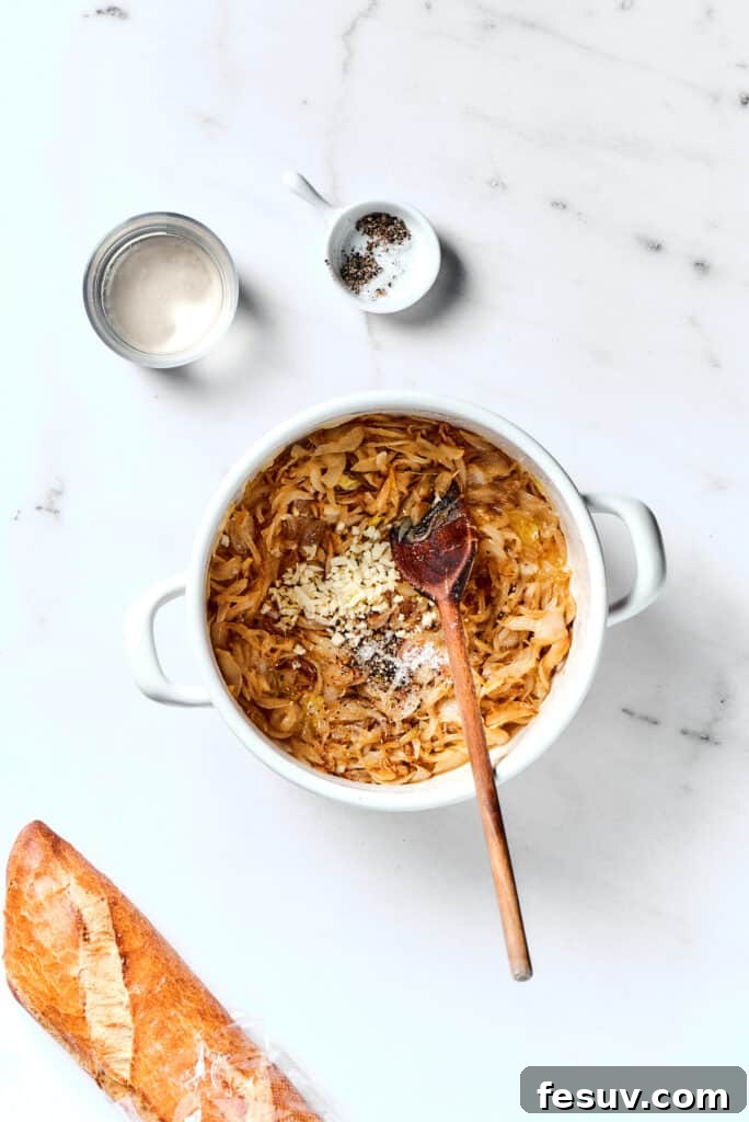Caramelized Onion Elixir 4 Caramelizing onions in a pot, with minced garlic just added, releasing its aromatic fragrance into the sweet onions.