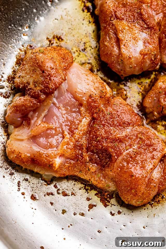 Moist, juicy & tender Cajun chicken thighs are flavorful, rich, and cooked in a spicy Cajun rub and topped with velvety butter sauce. Raw chicken thighs generously rubbed with a vibrant Cajun seasoning, ready for pan-searing.