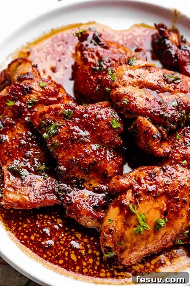 Moist, juicy & tender Cajun chicken thighs are flavorful, rich, and cooked in a spicy Cajun rub and topped with velvety butter sauce. Perfectly cooked Cajun chicken thighs on a white plate, generously topped with a rich, buttery pan sauce and fresh parsley.