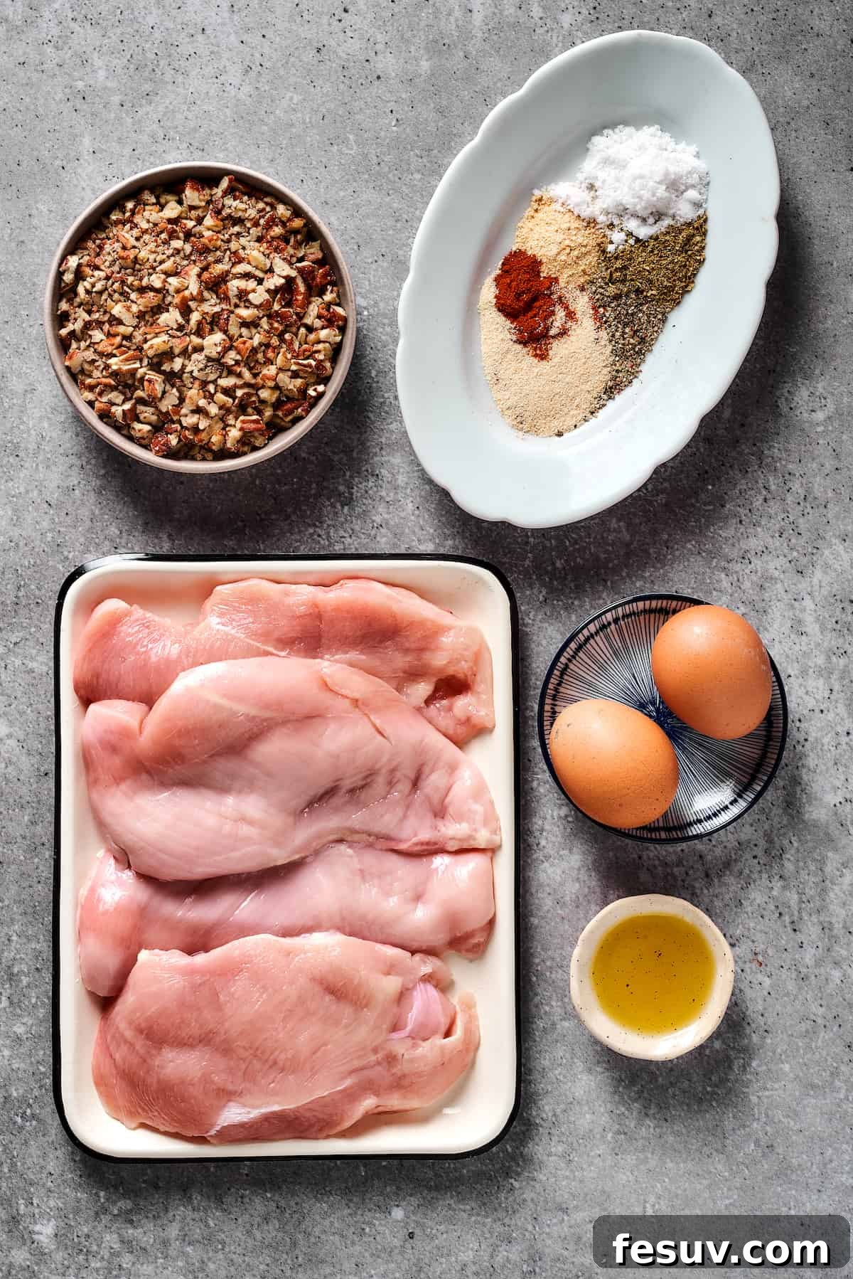 From top left: Chopped pecans, spices, chicken breast, eggs, olive oil.