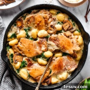 Creamy chicken and gnocchi in a cast-iron skillet.