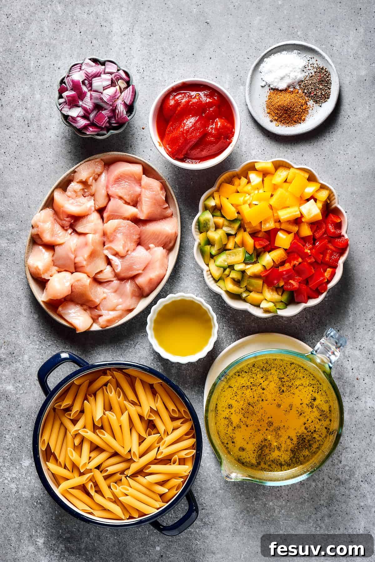 Chicken fajita pasta ingredients meticulously arranged in small dishes on a rustic wooden surface, ready for cooking.