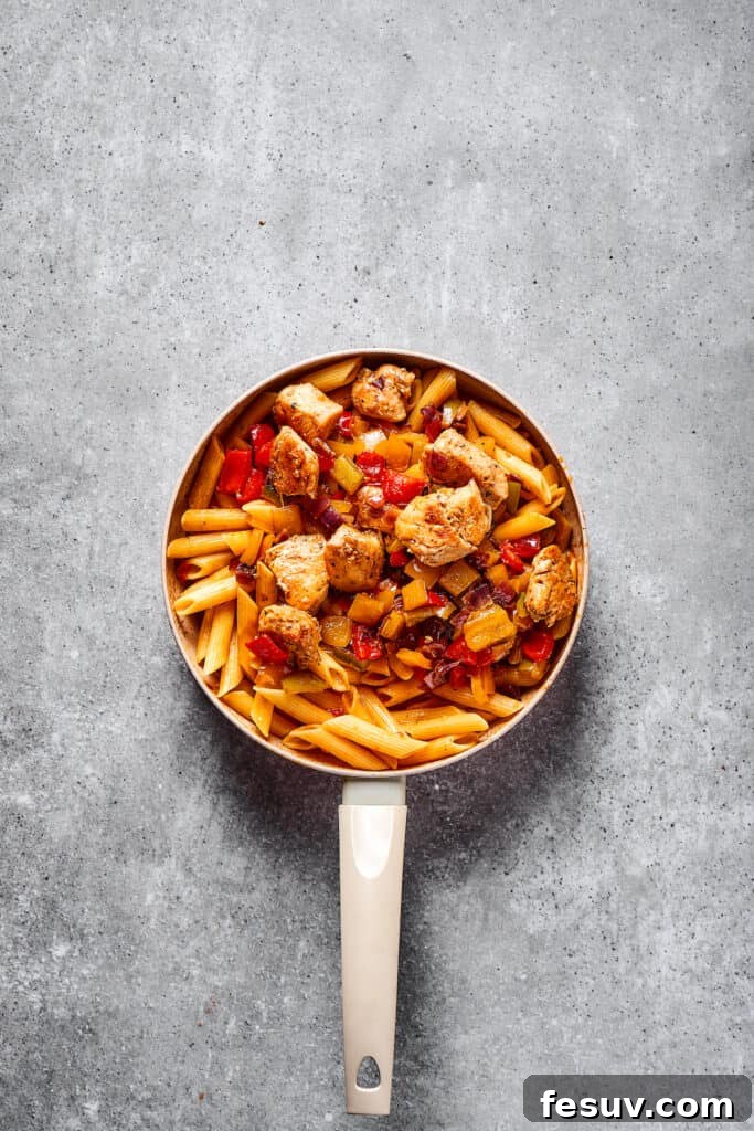The finished Chicken Fajita Pasta, a vibrant mix of penne, chicken, and vegetables, beautifully presented in the skillet.
