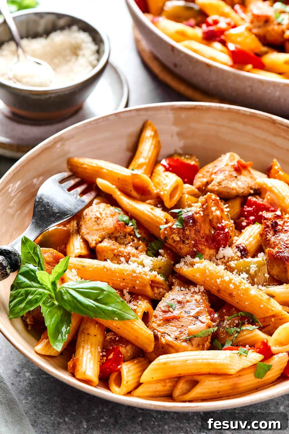 A serving of Chicken Fajita Pasta in a bowl, showcasing the penne, colorful vegetables, and chicken, ready to be enjoyed.