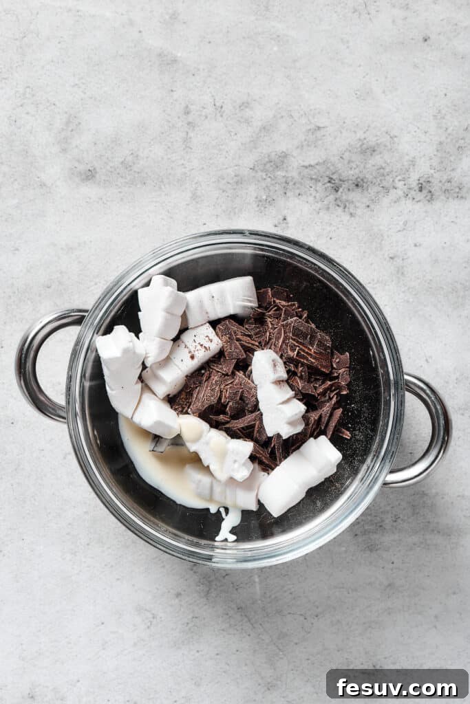 Irresistible Chocolate Krispie Squares 8 Chocolate and marshmallows in a pot.