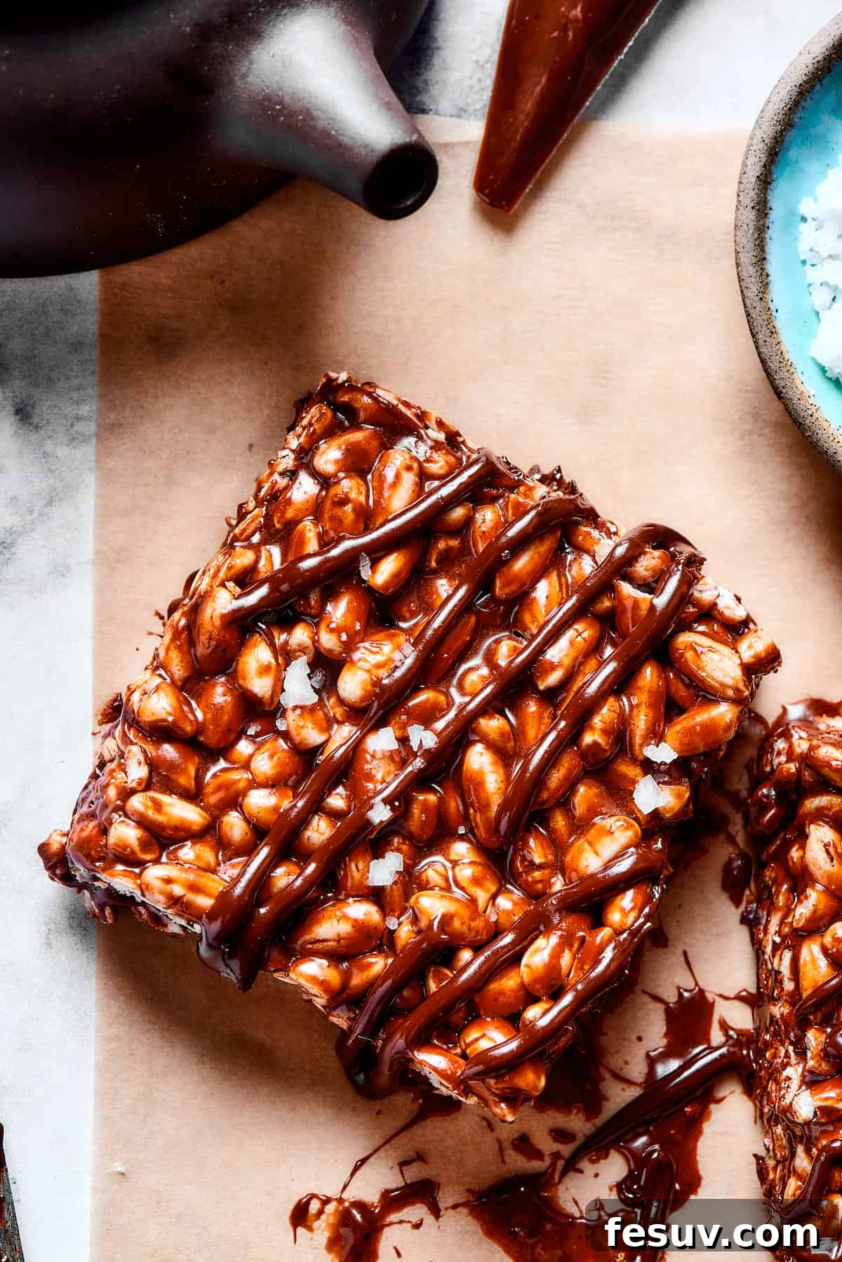 Chocolate Rice Krispie Treats are light and crunchy, with a sticky marshmallow texture and real dark chocolate. Easy and scrumptious! A chocolate rice and marshmallow square with chocolate drizzle.