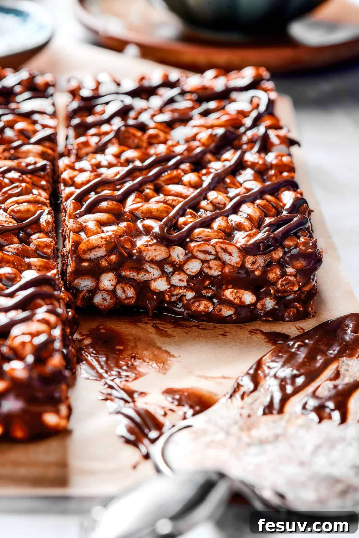 Chocolate Rice Krispie Treats are light and crunchy, with a sticky marshmallow texture and real dark chocolate. Easy and scrumptious! Squares of chocolate cereal bar with chocolate and marshmallow topping.