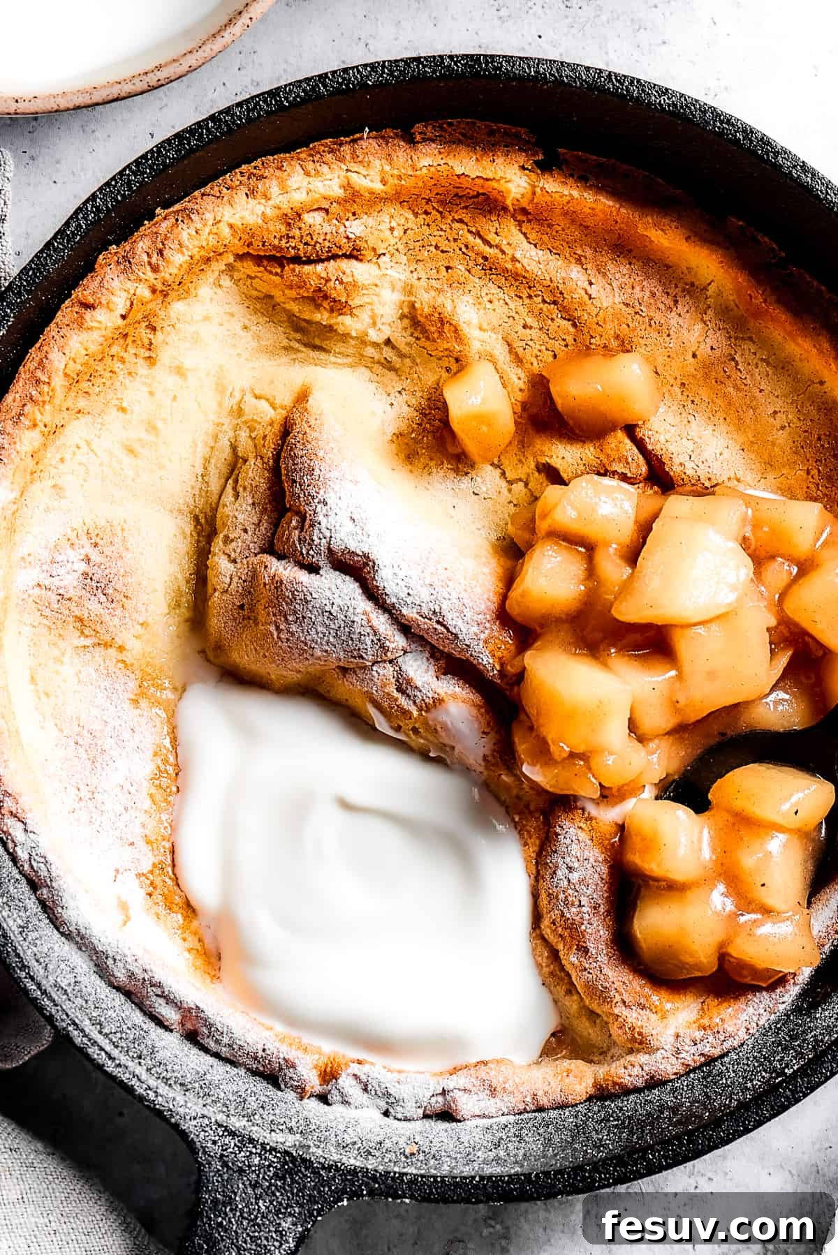 This old-fashioned Dutch Baby Pancake made in a cast-iron skillet is an easy, popover-like breakfast with homemade apple pie filling. Yum! A skillet pancake with apples and creamy topping.