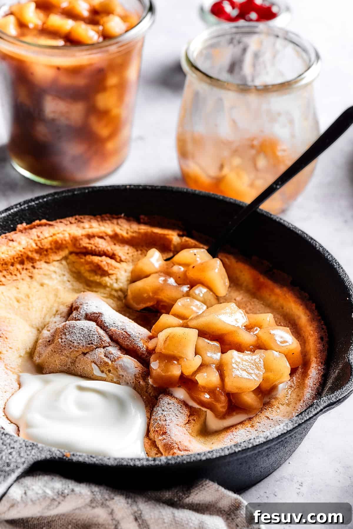 This old-fashioned Dutch Baby Pancake made in a cast-iron skillet is an easy, popover-like breakfast with homemade apple pie filling. Yum! A German pancake with yogurt and apple filling.