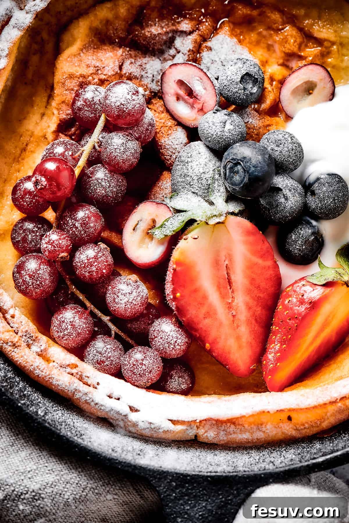 This old-fashioned Dutch Baby Pancake made in a cast-iron skillet is an easy, popover-like breakfast with homemade apple pie filling. Yum! A German pancake topped with powdered sugar and fresh fruit.