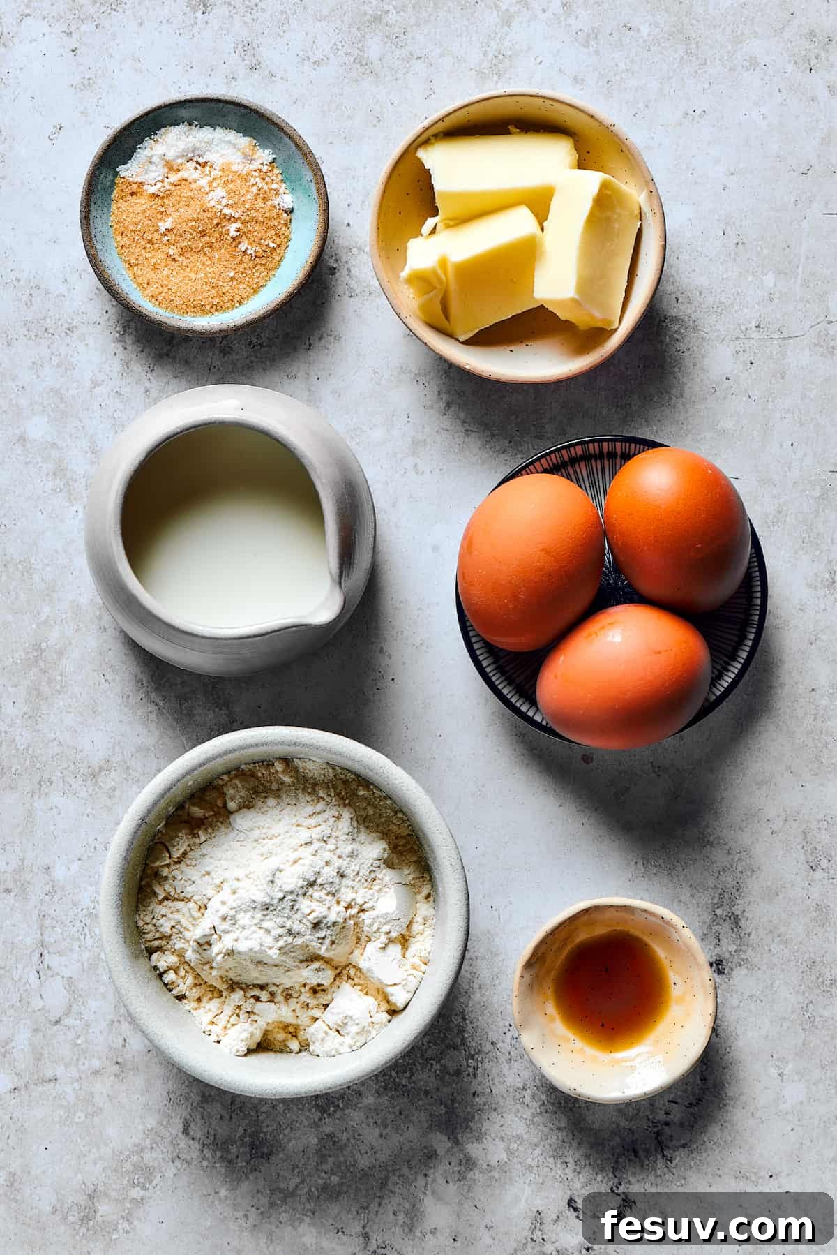 This old-fashioned Dutch Baby Pancake made in a cast-iron skillet is an easy, popover-like breakfast with homemade apple pie filling. Yum! Ingredients for a Dutch baby pancake measured into small dishes and arranged on a work surface.
