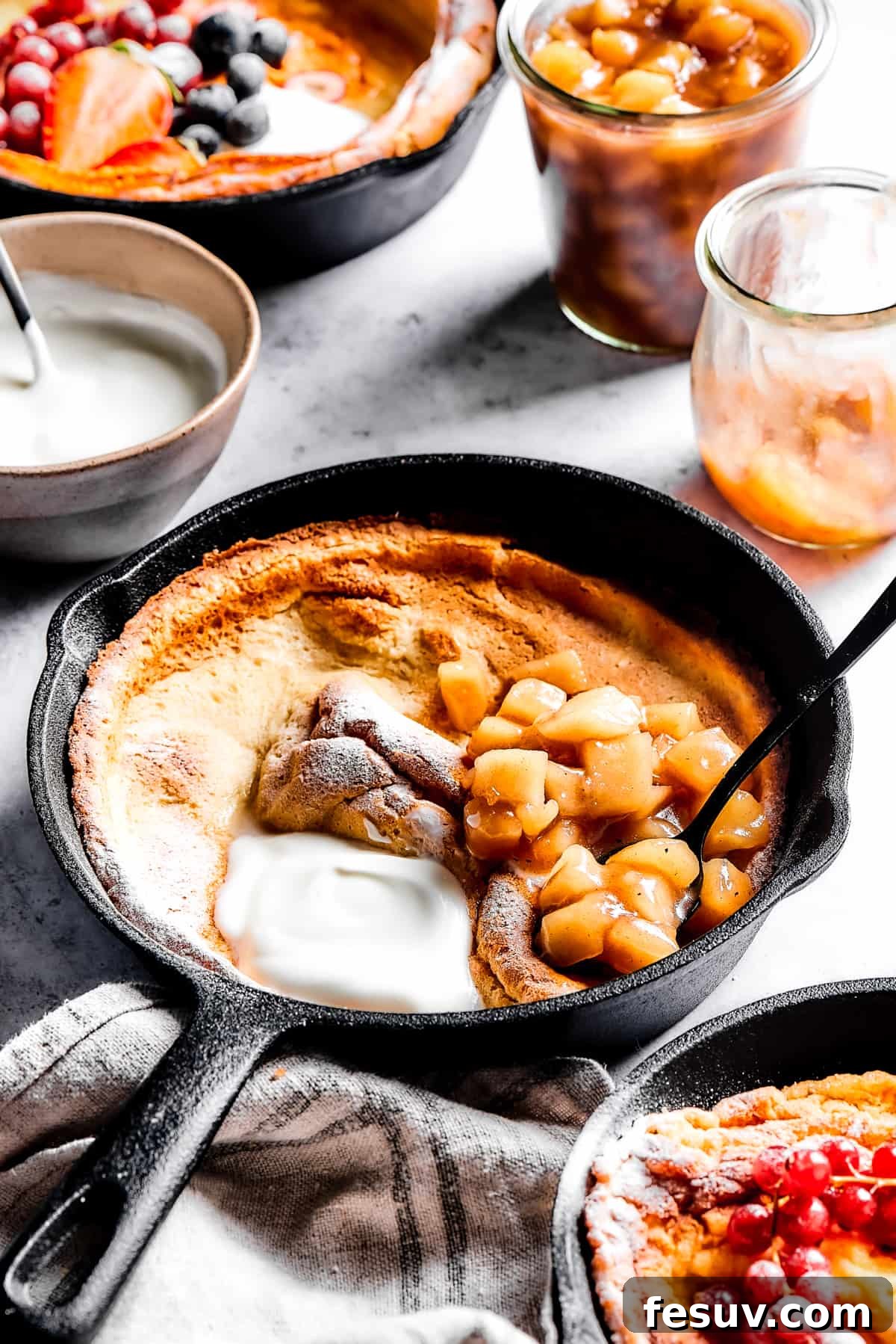 This old-fashioned Dutch Baby Pancake made in a cast-iron skillet is an easy, popover-like breakfast with homemade apple pie filling. Yum! Dutch baby with apple filling.