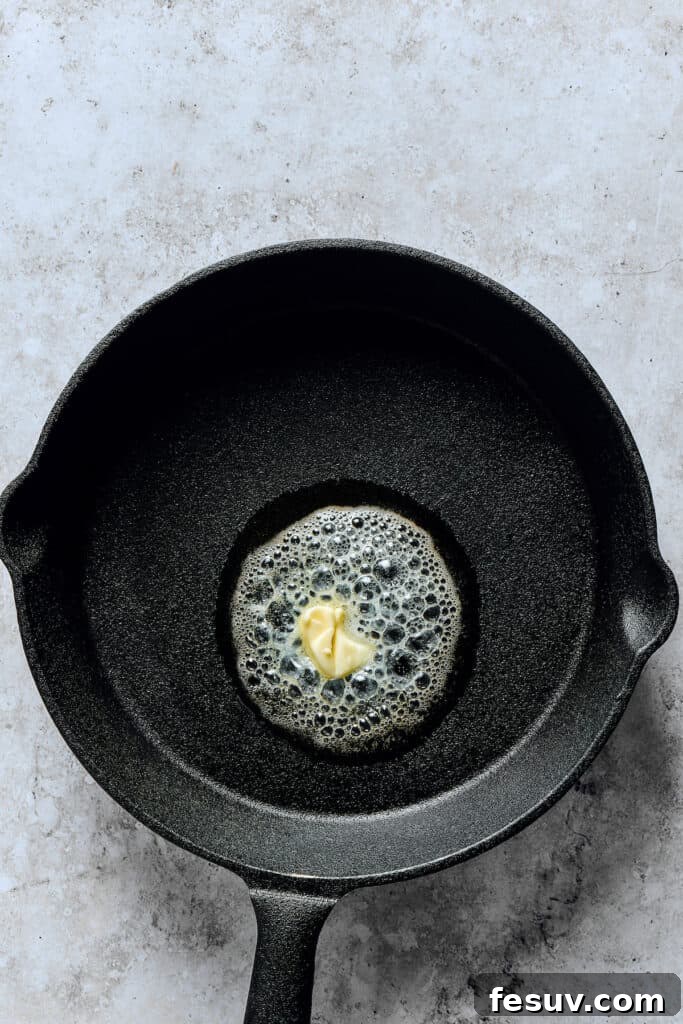 Skillet Cloud Pancake 3 Melting butter in a skillet.