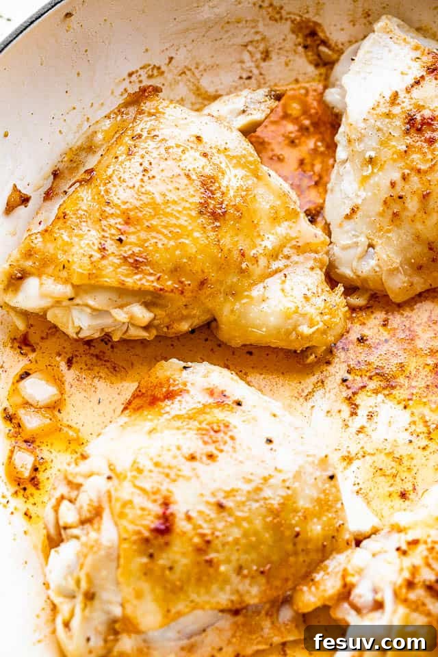 This one pot chicken and rice recipe is a whole meal - tender, pan seared chicken thighs, sautéed veggies, and creamy rice. So good! frying chicken thighs in pan
