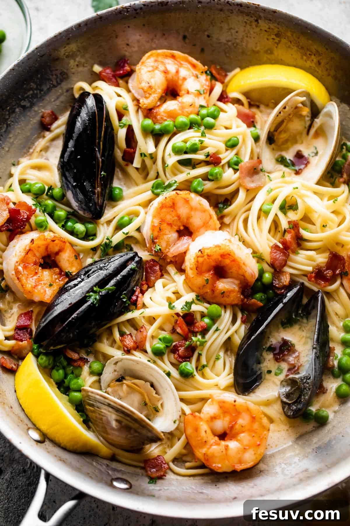 Velvet Seafood Pasta 4 a skillet with pasta, shrimp, and mussels in cream sauce.