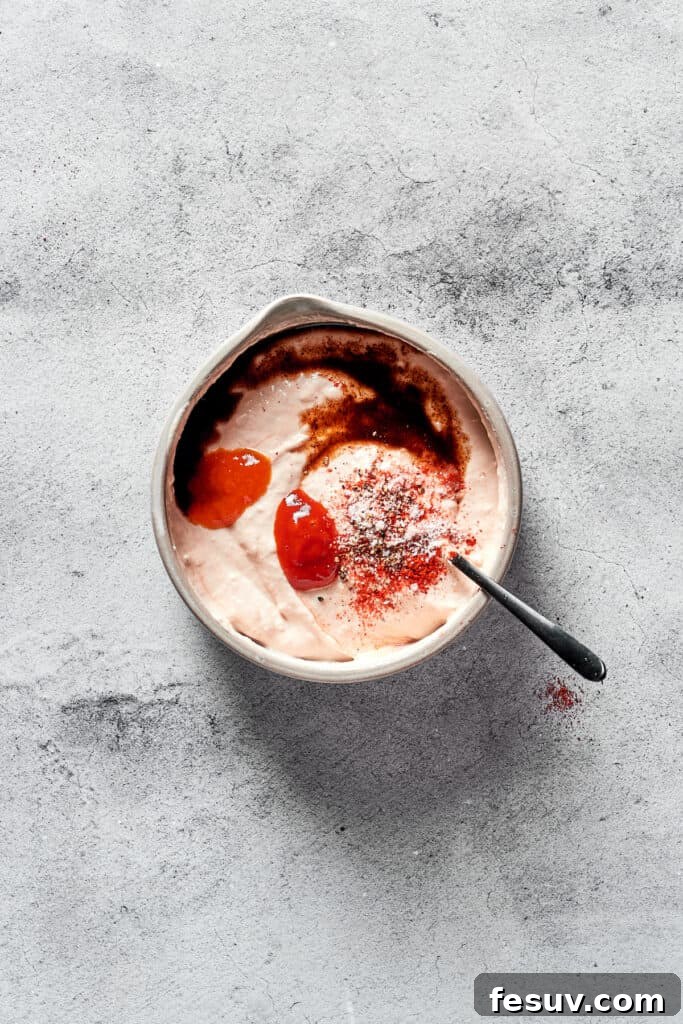 All the Russian dressing ingredients have been combined in a small mixing bowl and whisked to a smooth, creamy consistency, ready to enhance your Reuben sandwich.