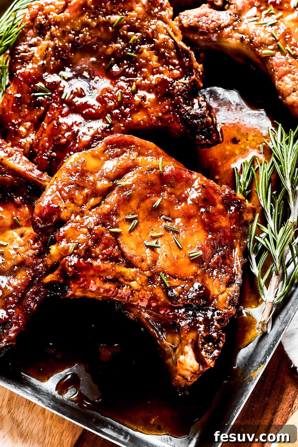 Gorgeous Brown Sugar Pork Chops: Sweet and Savory Pan-Fried Delight Pork chops glazed in brown sugar sauce, garnished with fresh herbs, ready to serve.