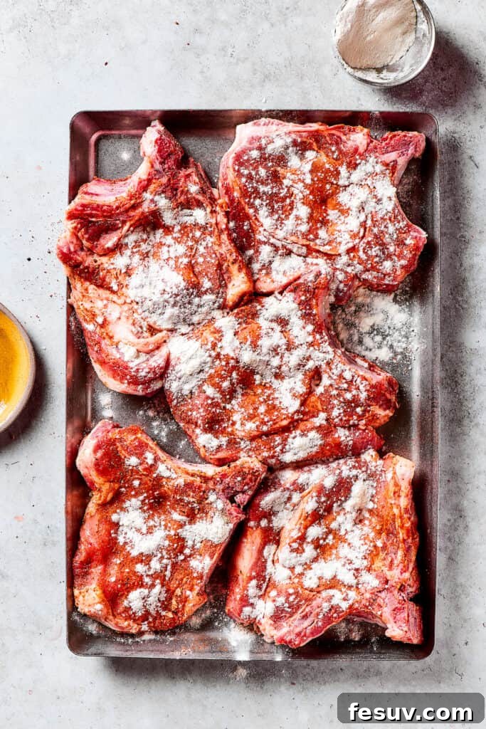 Dredged Pork Chops with Seasoned Flour Pork chops evenly coated with a seasoned flour mixture.