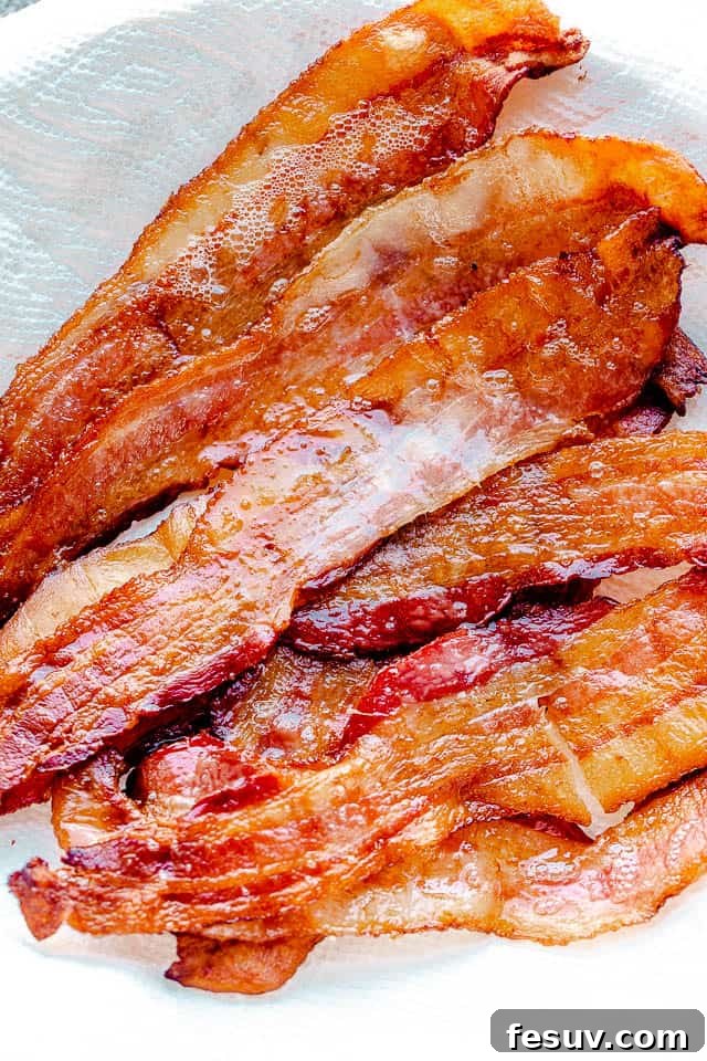 Image of a plate filled with beautifully oven baked bacon, ready to be served.