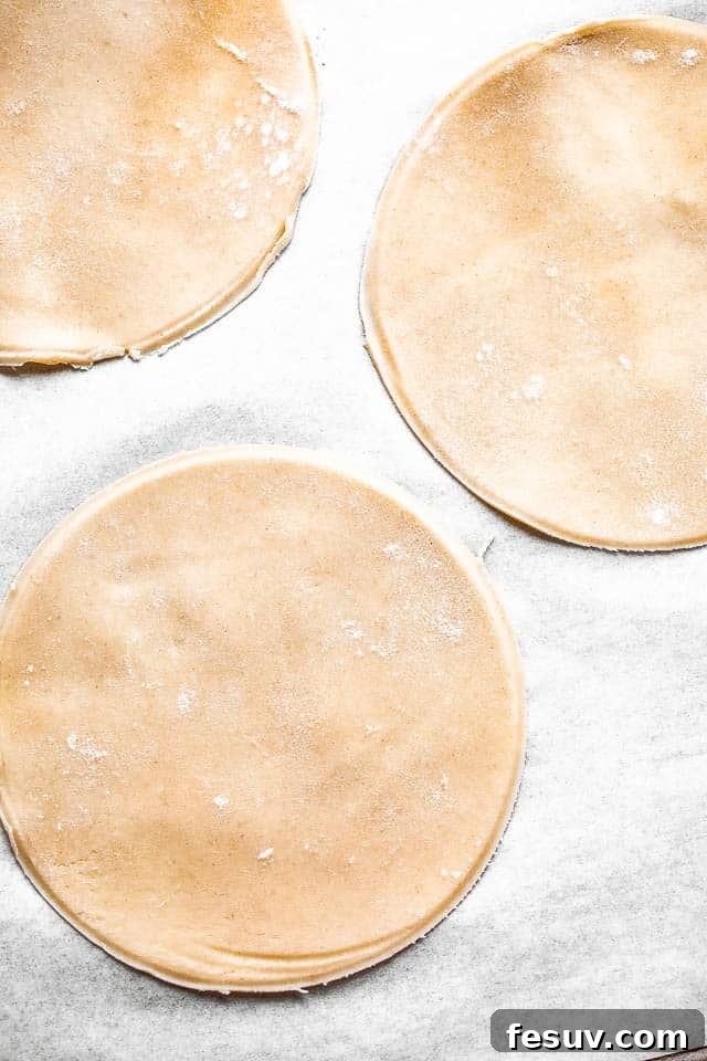 pie dough cut into small rounds on a floured surface