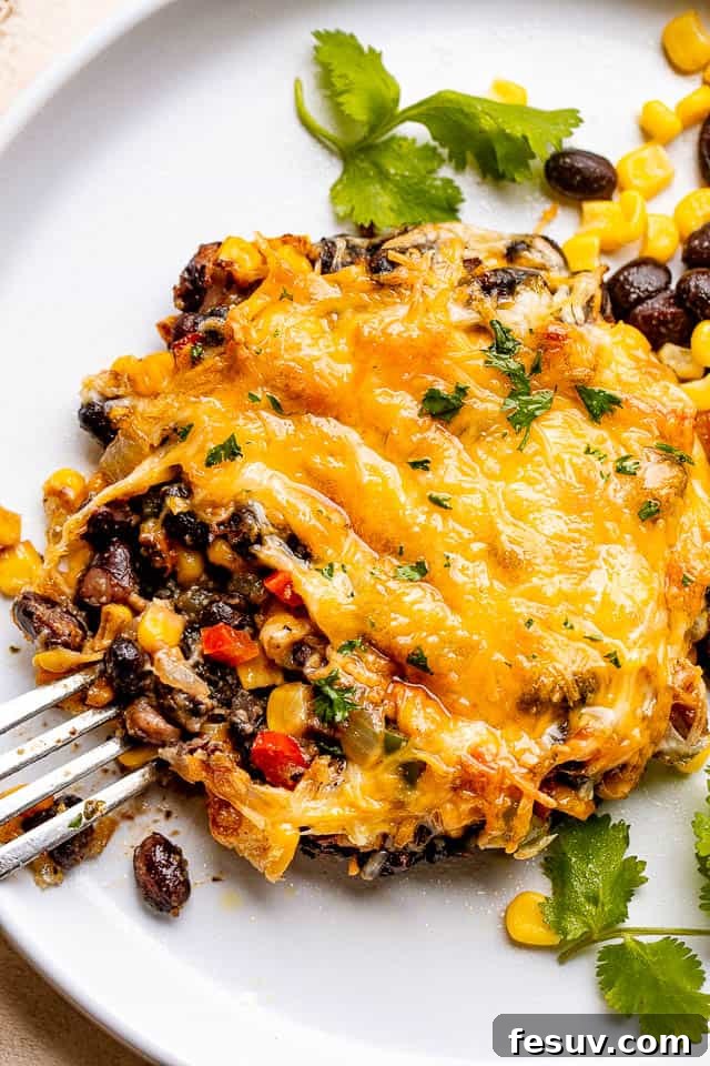Fiesta Stuffed Portobello Caps 2 fork next to a mushroom stuffed with corn, black beans, and cheese