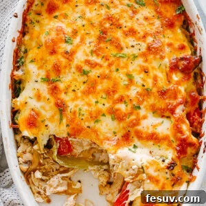 top view of chicken fajita casserole in an oval baking dish topped with melted cheese