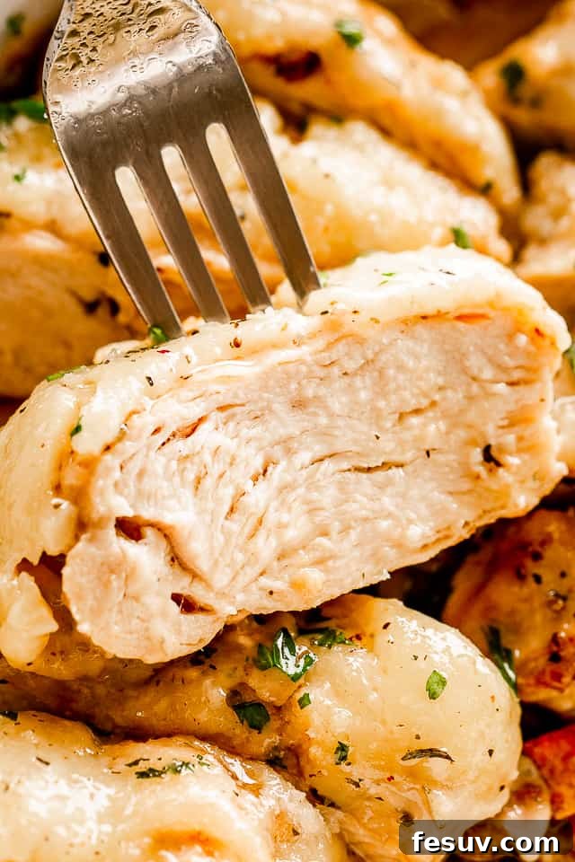 Zesty Caesar Baked Chicken 6 close up view of a fork set through a slice of chicken breast