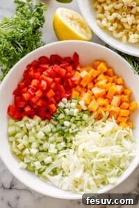 Bowl of macaroni salad ingredients laid out.