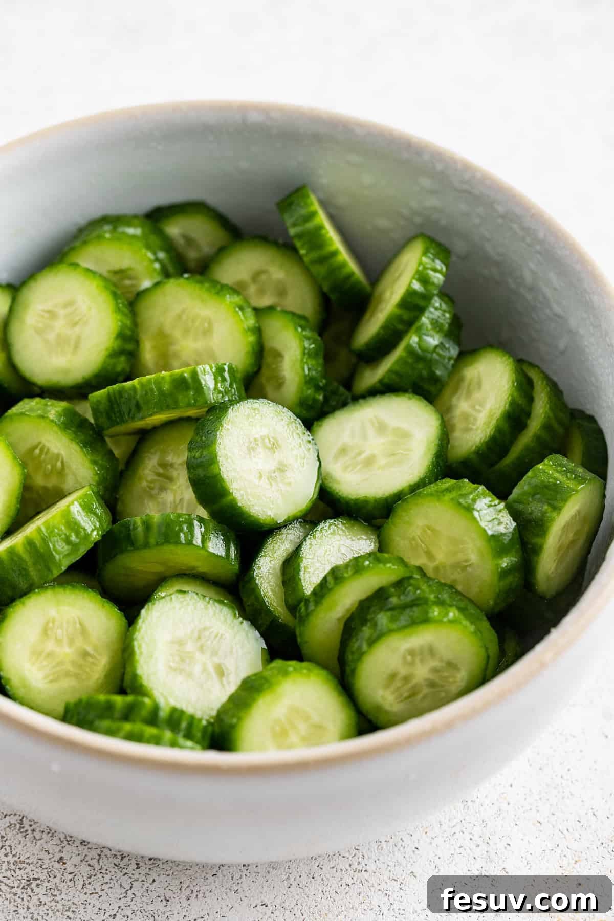 Salting the cucumbers.