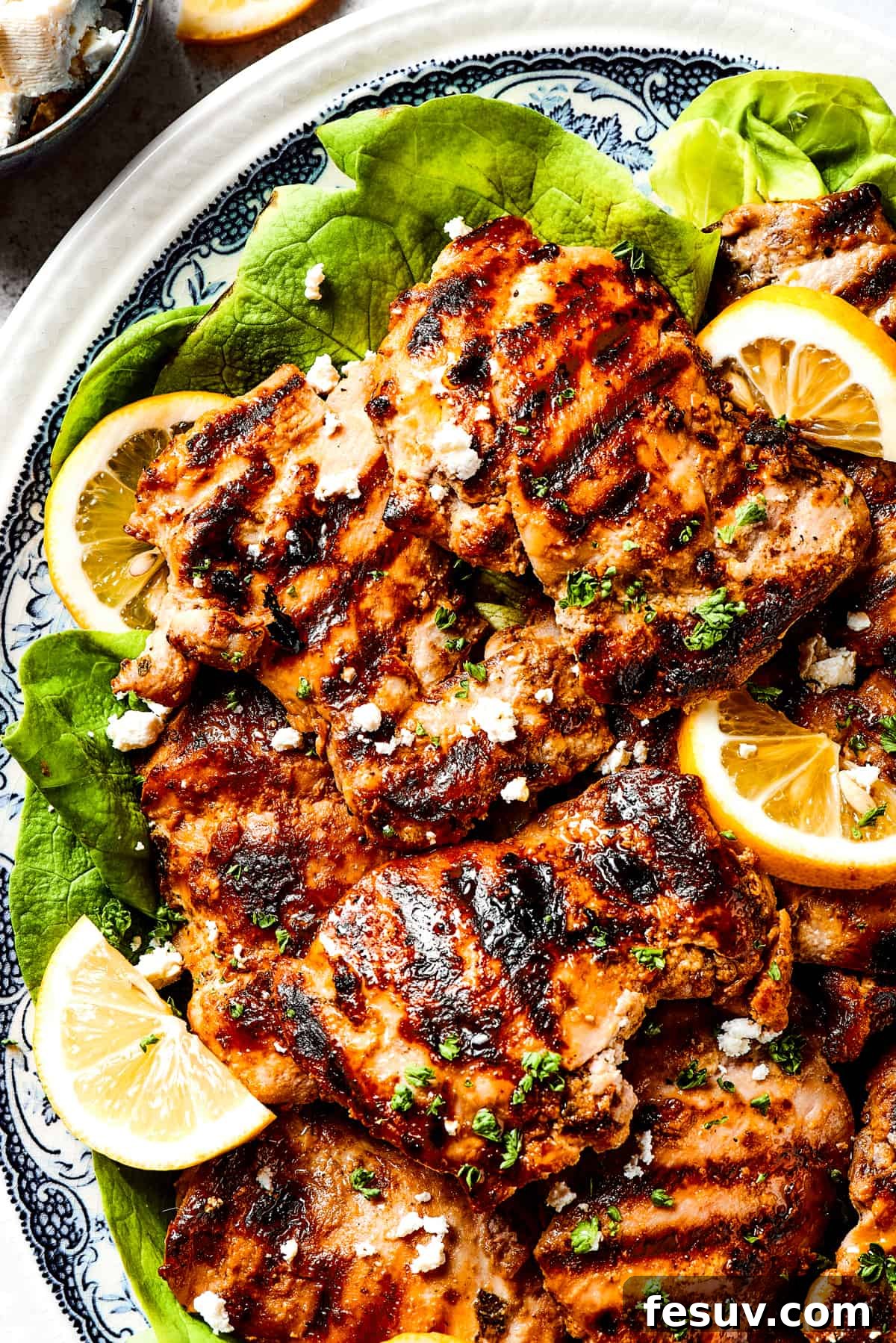 Yogurt Marinated Chicken: Your Go-To Recipe for Moist, Tender, and Flavorful Grilled Chicken! A beautifully arranged platter of golden-brown yogurt-marinated chicken, showcasing perfect grill marks and garnished with fresh herbs and lemon slices.