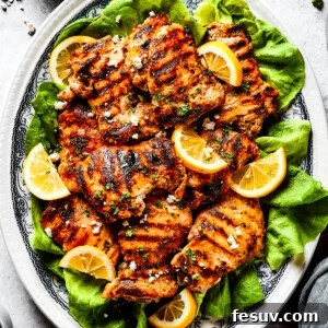 Velvet Yogurt Chicken 3 Grilled chicken thighs and lemon slices on a bed of salad greens.
