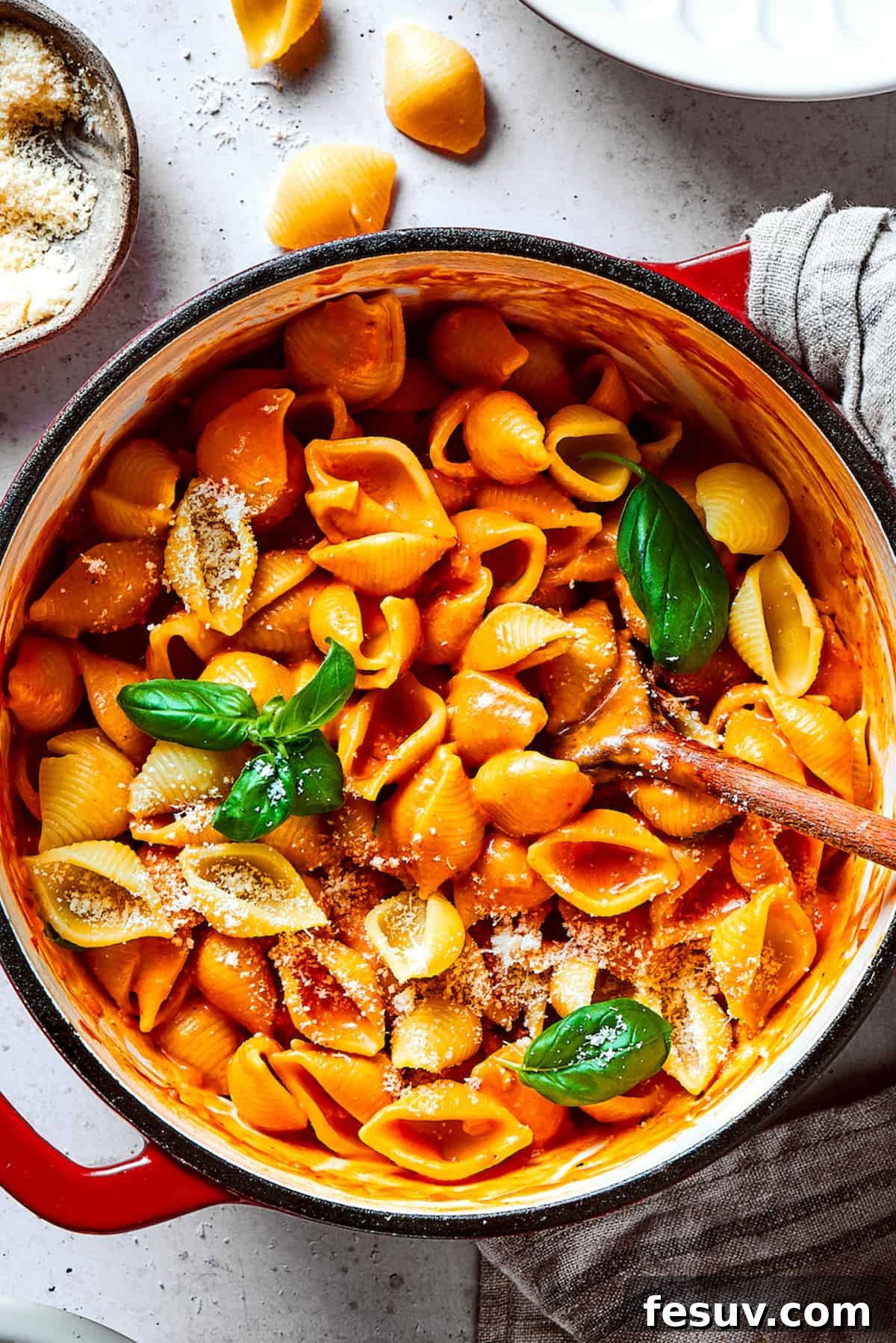 A pot of pasta shells coated in a rich, creamy tomato sauce, ready to serve.