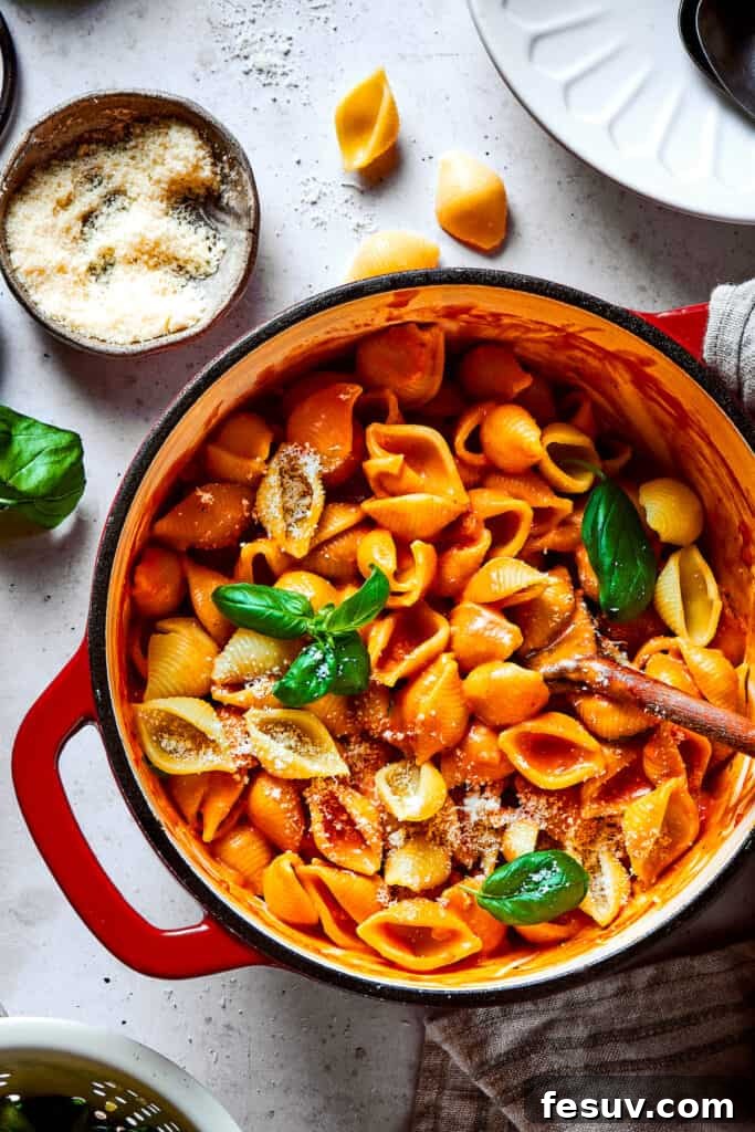 The cooked pasta shells perfectly coated in the luscious creamy tomato sauce, ready for serving.