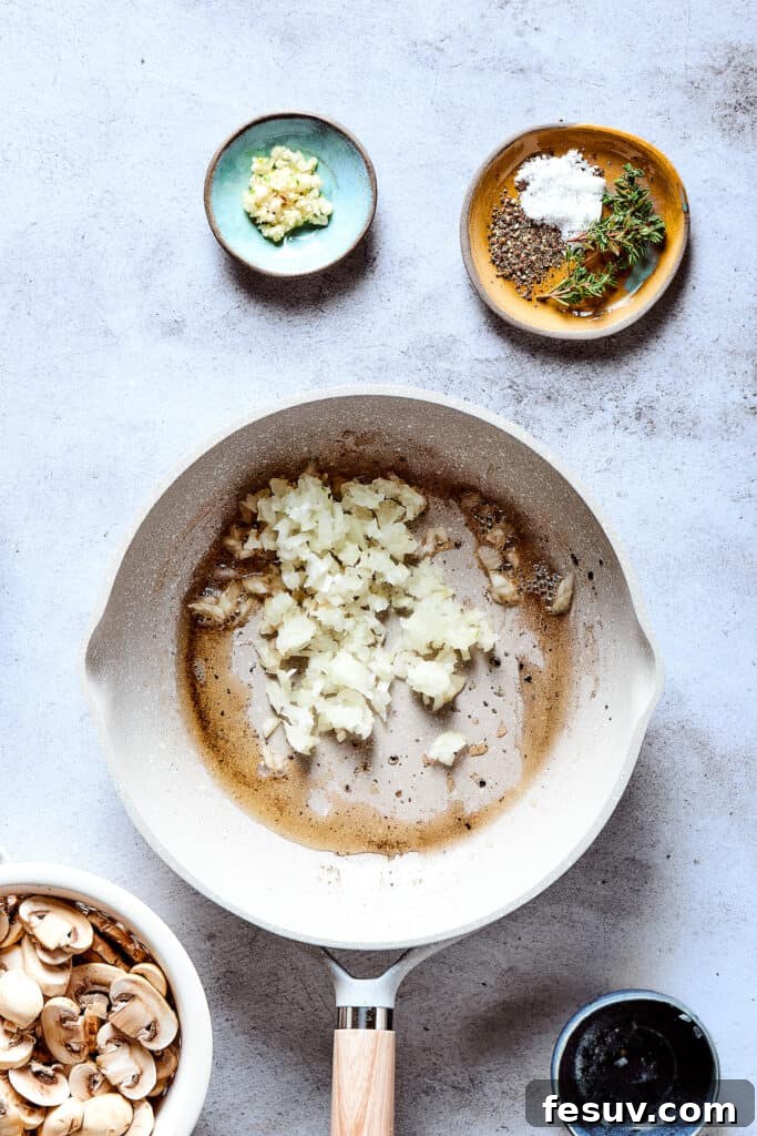 Butter and chopped onions are shown sautéing in a hot skillet, forming the flavorful base for the mushroom gravy.