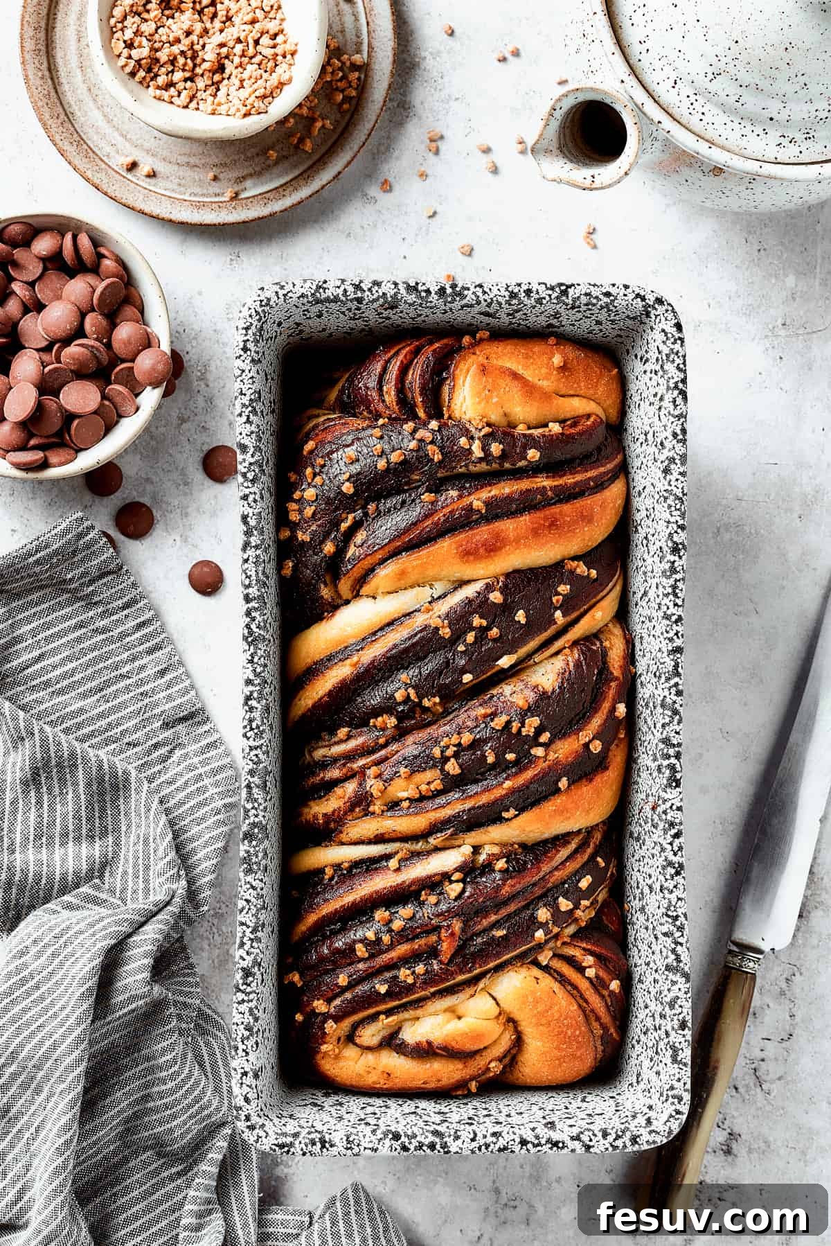 A baked chocolate babka in a loaf pan.