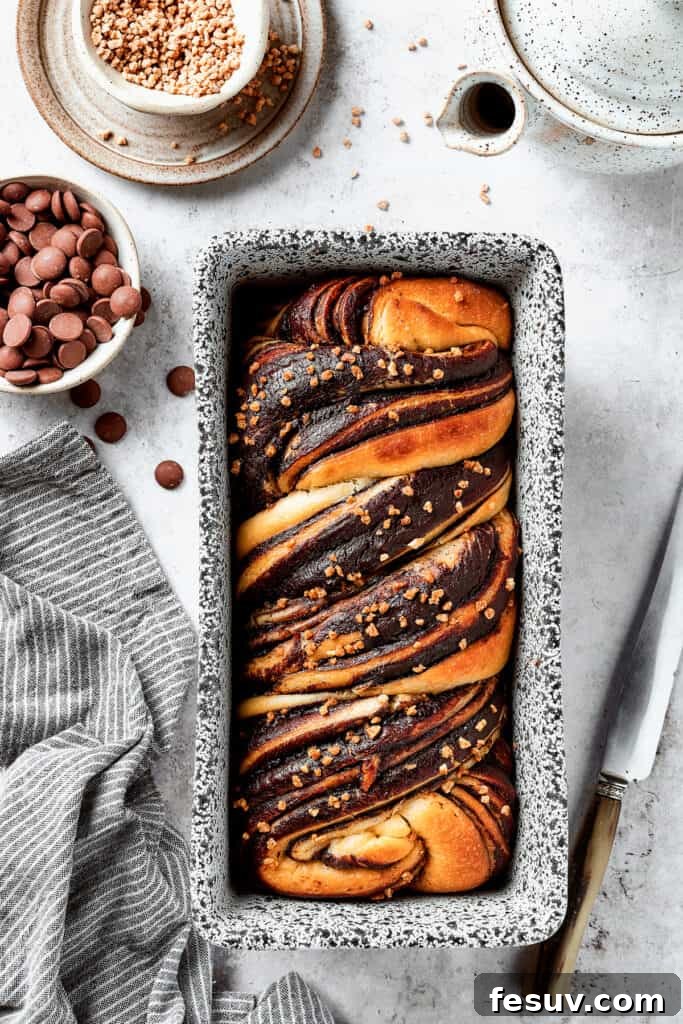 A baked chocolate babka in a loaf pan.