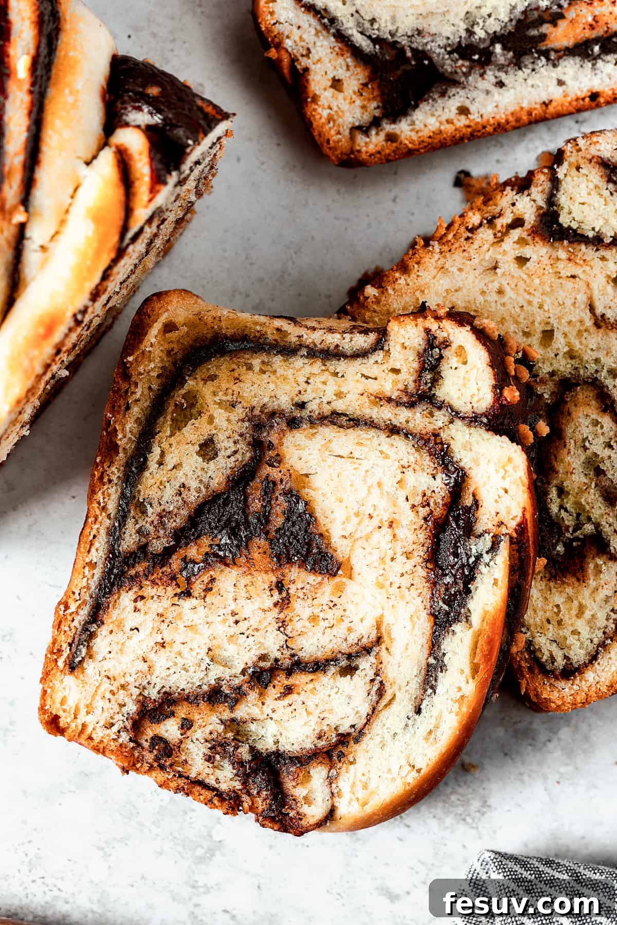 Slices of chocolate babka on a work surface.