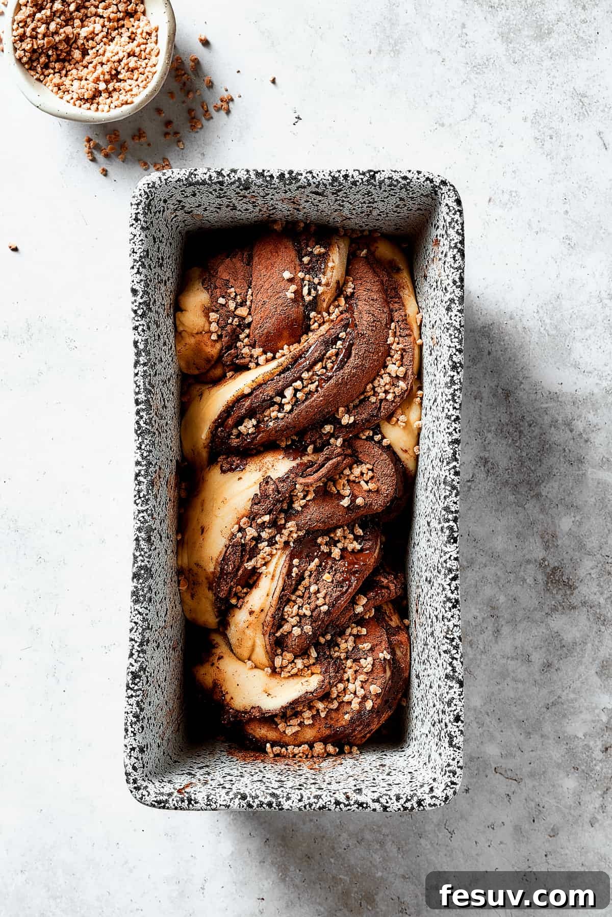 Twisted lengths of chocolate-filled dough placed in a loaf pan.